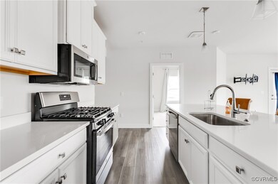 Kitchen featuring stainless steel appliances, dark