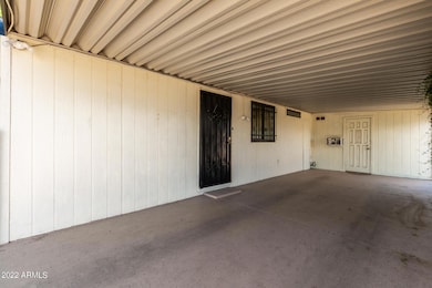 Carport with side entry and workroom