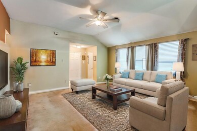 Virtually staged Living room with carpet, vaulted 