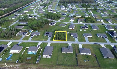 Aerial overview of property's location featuring nearby suburban area and property parcel outlined