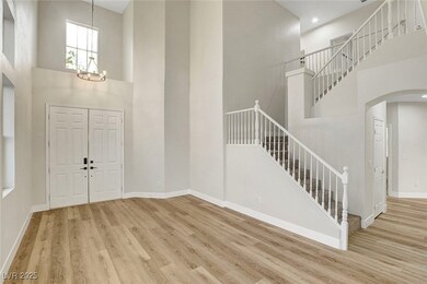 Foyer entrance with arched walkways, wood finished