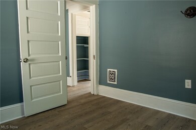 Empty room with dark wood-type flooring