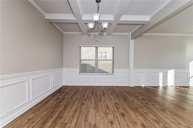 Unfurnished dining area with a chandelier, beamed 