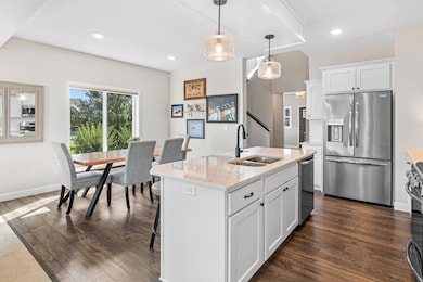 Abundant natural light pours in through large windows, highlighting the crisp finishes and spacious layout. Whether you're entertaining or enjoying a quiet morning coffee, this bright and airy kitchen is the place you will want to be.