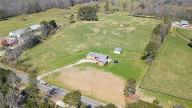 Aerial view of property and surrounding area featuring rural landscape and agricultural land