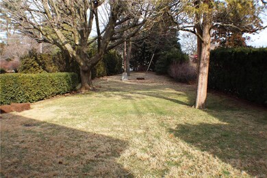 Deep, private back yard, with trees and a flag pol
