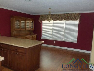 Kitchen featuring kitchen peninsula, dark hardwood