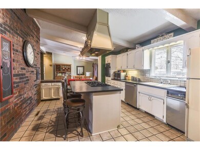 Kitchen View shows door in fireplace to indoor gri