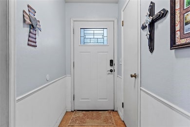 Doorway featuring light tile patterned floors