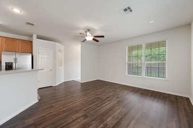 Unfurnished living room with a ceiling fan, dark 