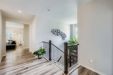 View upon walking in front door.  Amazing built in bookshelves with ladder surprise you at the landing of the stairs