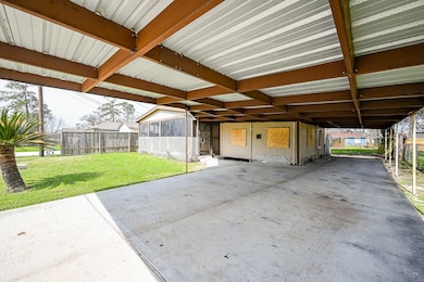Spacious carport, perfect for shaded outdoor activities or even changing your own oil!