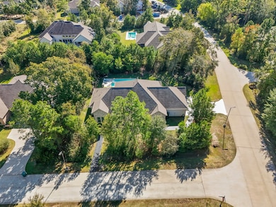 Beautiful curb appeal on a peaceful street with towering trees framing the property for a serene natural setting.