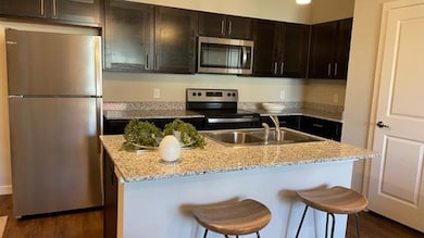Kitchen featuring light stone counters, stainless 