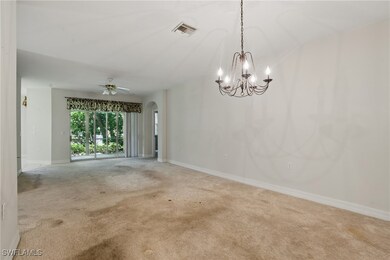 Spare room featuring arched walkways, carpet, a ch