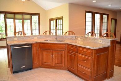 Kitchen island open to breakfast nook and living a