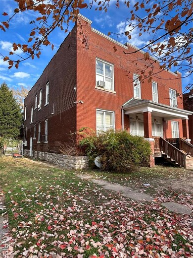 View of side of home with brick siding and covered porch