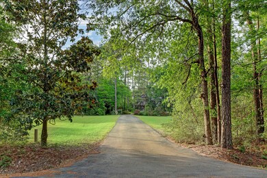Enter this magnificent property via a private driveway. Feels like 7.5 acres with the 5 acre easement surrounding the property!