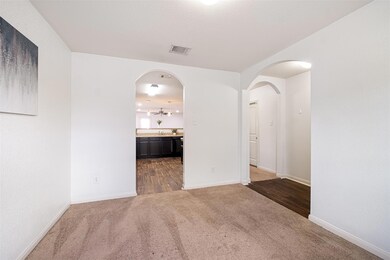 Unfurnished room featuring dark colored carpet an