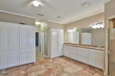 Bathroom featuring ornamental molding, vanity, an 