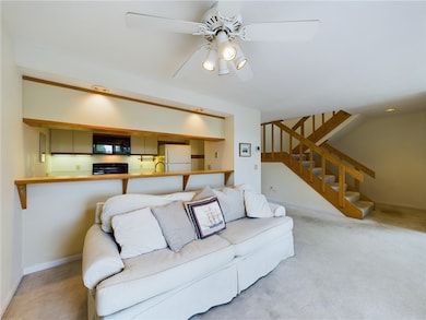 Stairs up to primary bedroom, down to garage/entry