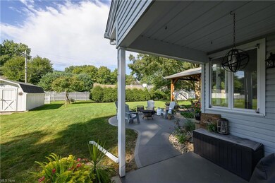 View of patio featuring a shed and an outdoor livi