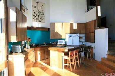 Open kitchen with center island and 19' clear ceil