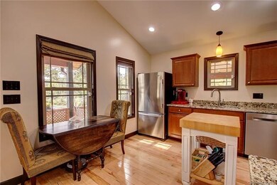 Kitchen features stainless appliances, ample counter space.