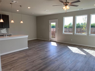 Unfurnished living room featuring a sink, a ceili