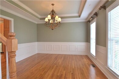 The formal dining room has a tray ceiling and a ni