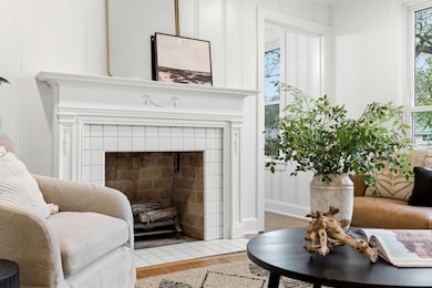 The beautiful gas fireplace, surrounded by an elegant mantle and delicate tile work, creates a focal point for the room's decor.