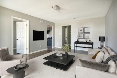 Living room featuring wood-type flooring and a tex