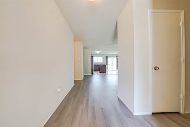 Corridor featuring baseboards and light wood-style floors