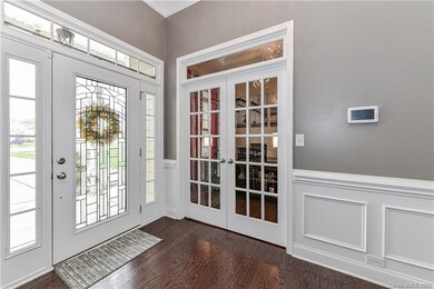 Entryway Includes Crown, Chair Rail, & Picture Frame Moldings As Well As Gorgeous Hardwood Flooring