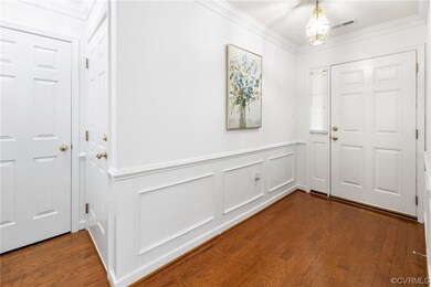 Hardwood floored entrance foyer with crown molding