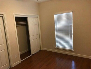 Unfurnished bedroom featuring baseboards and dark