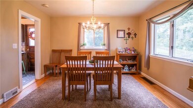 Dining room has hardwood floors and a pretty backy