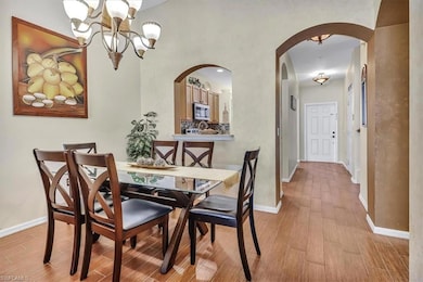 Dining area featuring a notable chandelier and lig
