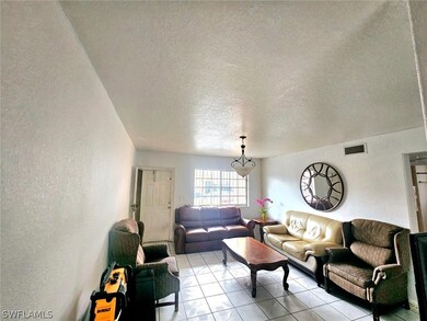 Tiled living room with a textured ceiling