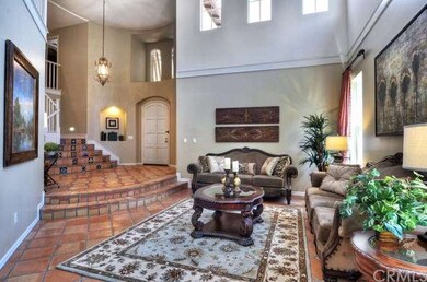 Formal living room with high ceiling and lots of w