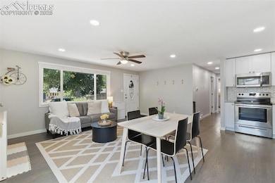 Dining area with dark wood-style flooring, recessed lighting, and a ceiling fan