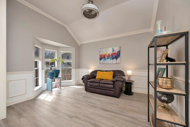Living area featuring a wainscoted wall, laminate 