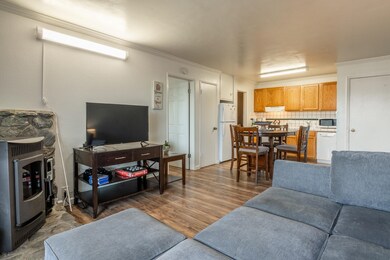 Living room featuring crown molding and light wood-style floors