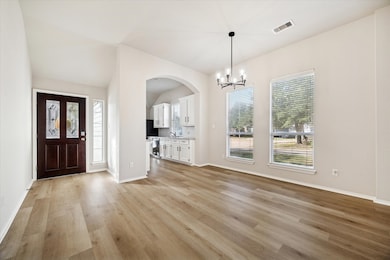The living and dining areas filled with natural light blend beautifully, creating a warm, connected space where family and friends can gather.
