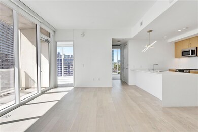 Unfurnished living room featuring a sink, light w