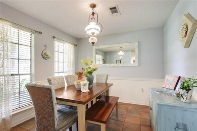 Dining room has soft colors, tile flooring and nat