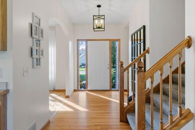 Foyer is open and bright w/ modern pendant lighting
