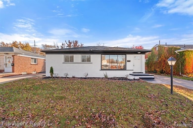 Ranch-style home with a front yard and brick siding