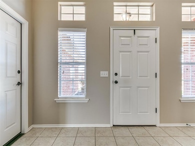 Entrance foyer with light tile patterned flooring 