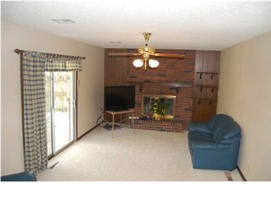 MAIN FLOOR FAMILY ROOM WITH FIRPLACE AND DOORS TO 